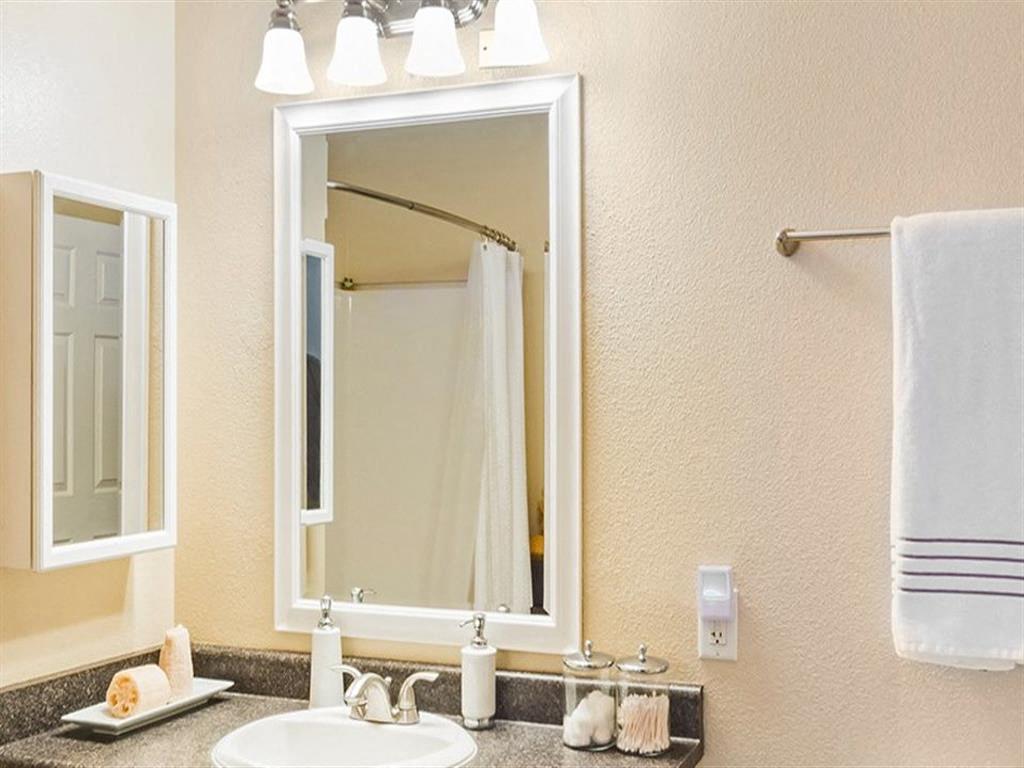 A bathroom with a white sink and a mirror.