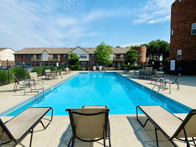 lounge chairs by pool at Abbey Court Apartments