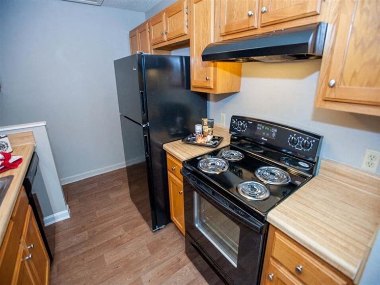 apartment kitchen with fridge and range