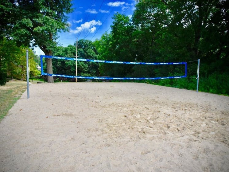 sand volleyball court at The Bronco Club Apartments