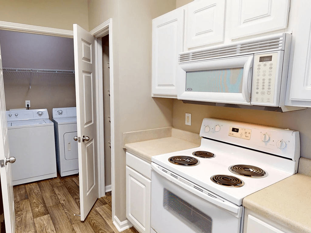 apartment kitchen with appliances including microwave