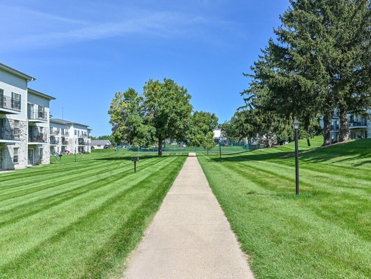 sidewalk in beautiful open area at apartment grounds