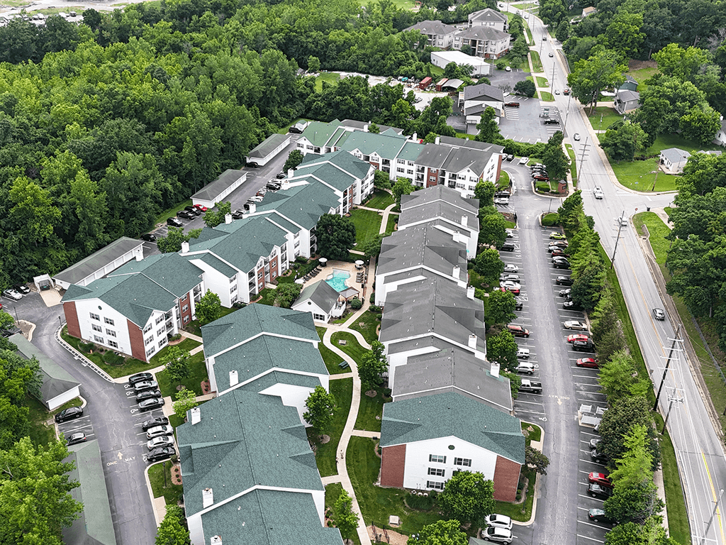A bird's eye view of a residential area with houses and cars.