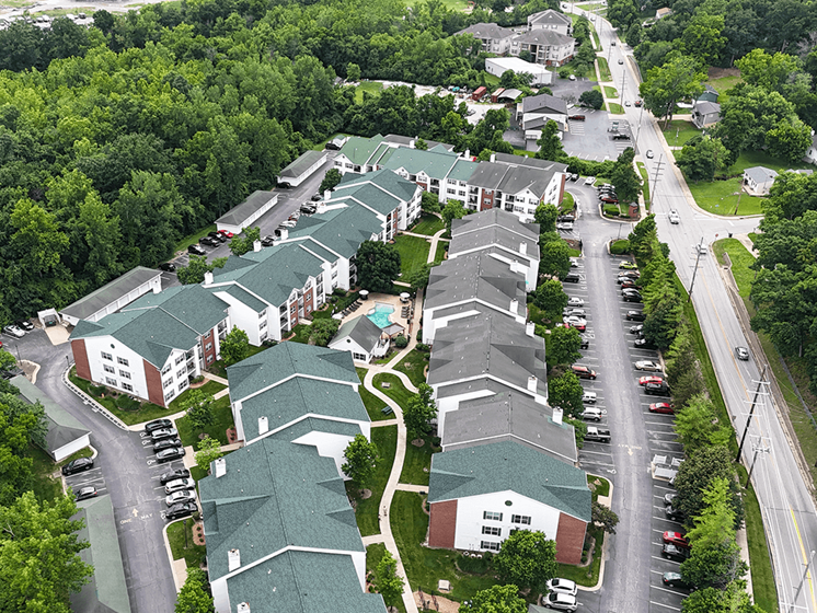 A bird's eye view of a residential area with houses and cars.