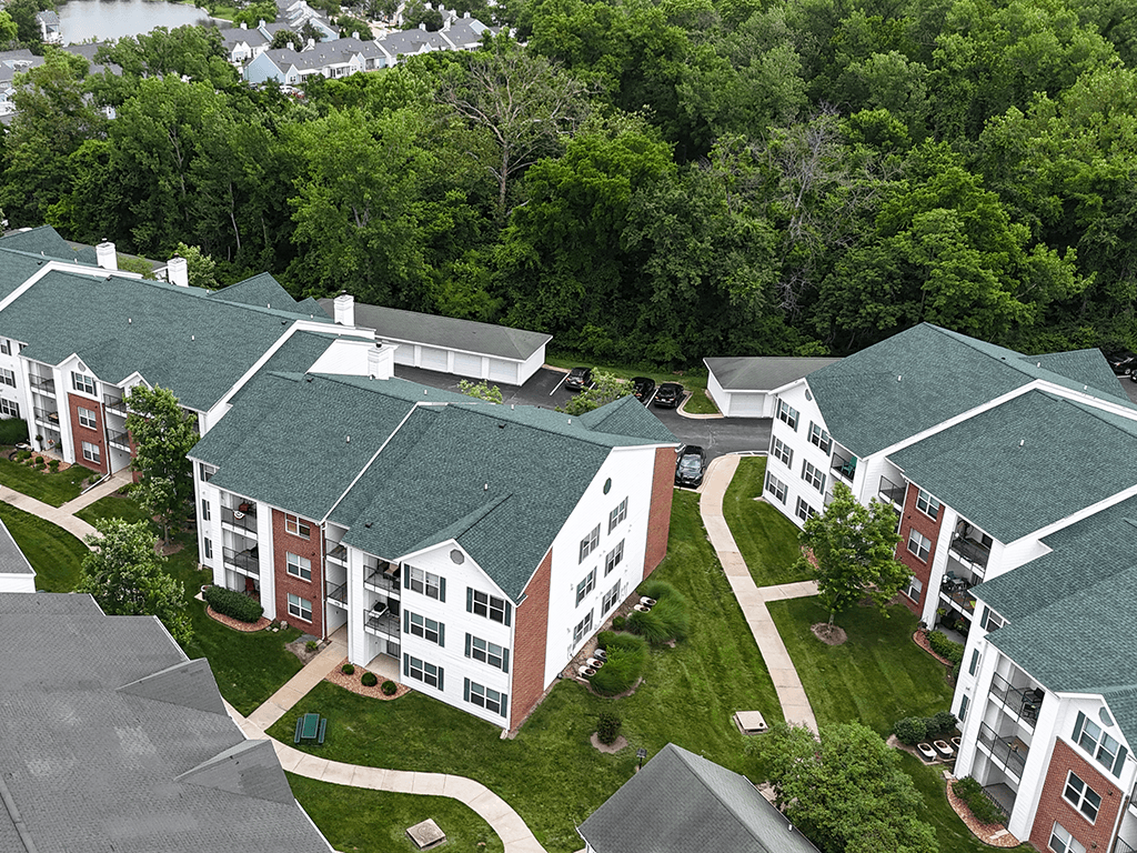 A large building complex with green roofs and a courtyard in the center.