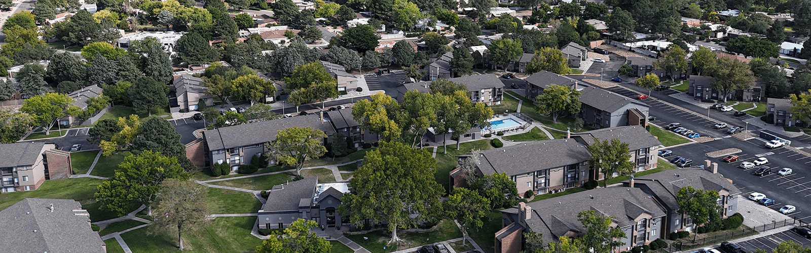 A bird's eye view of a residential neighborhood with houses and trees.