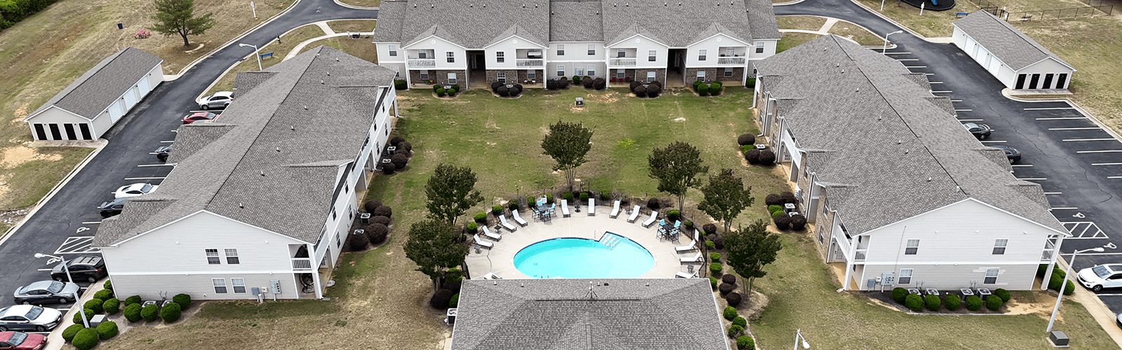 A large white building with a pool in the middle of it.