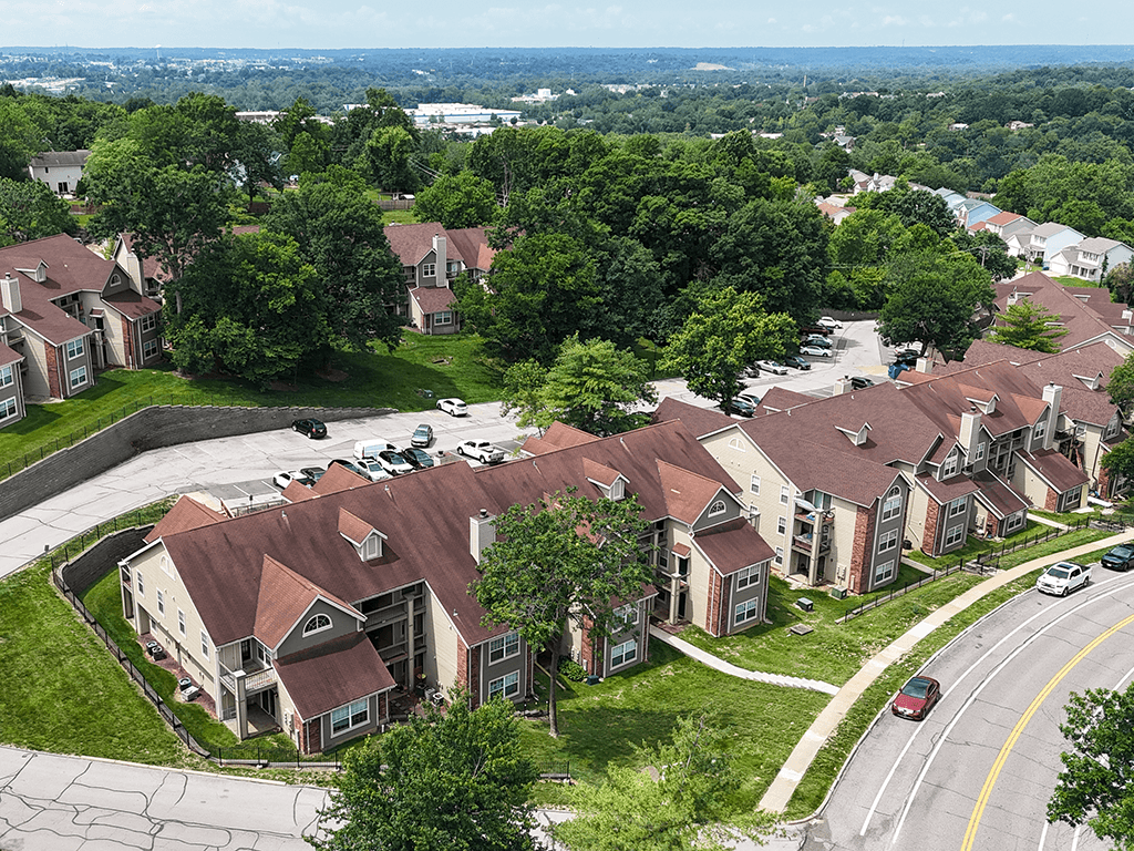 A bird's eye view of a residential area with houses and cars.