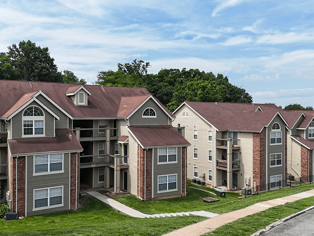 Apartment complex with a mix of grey and beige buildings.
