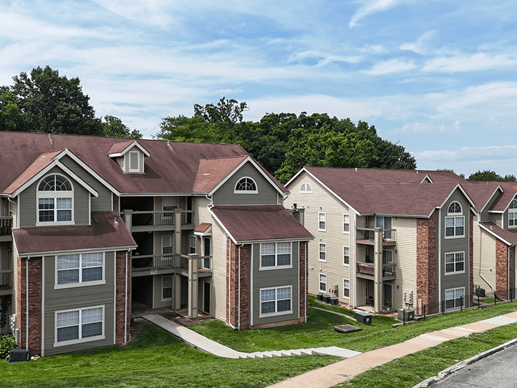 Apartment complex with a mix of grey and beige buildings.