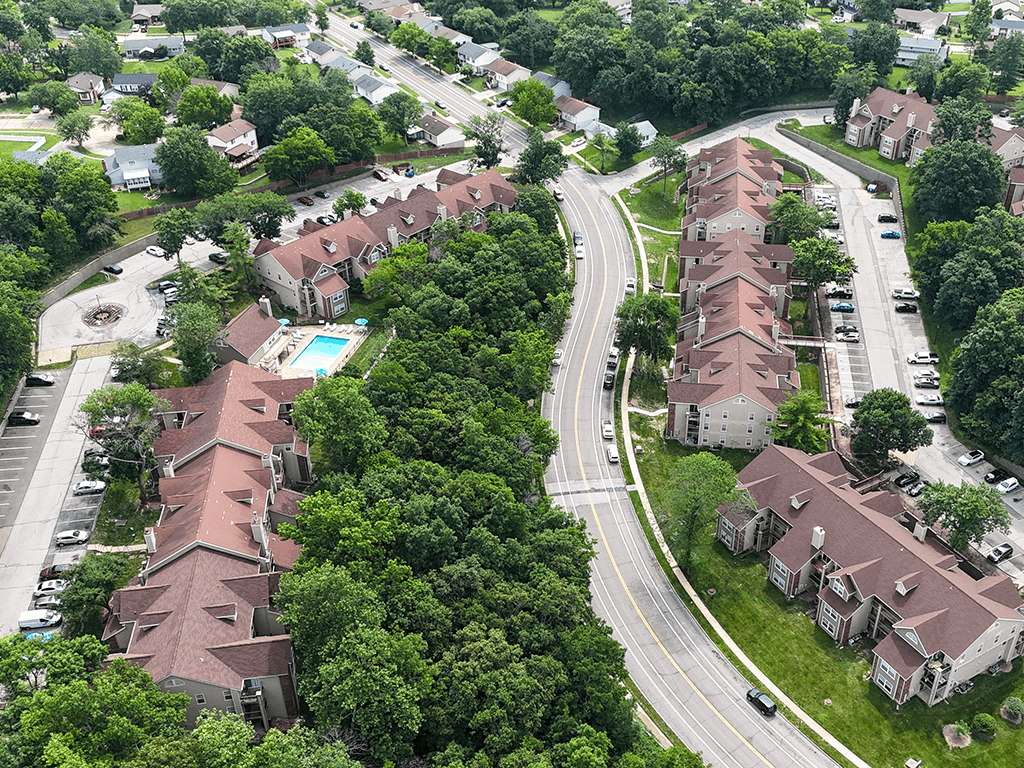 A bird's eye view of a residential area with houses and a road.