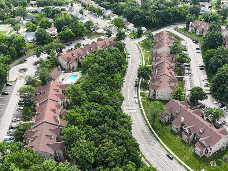 A bird's eye view of a residential area with houses and a road.