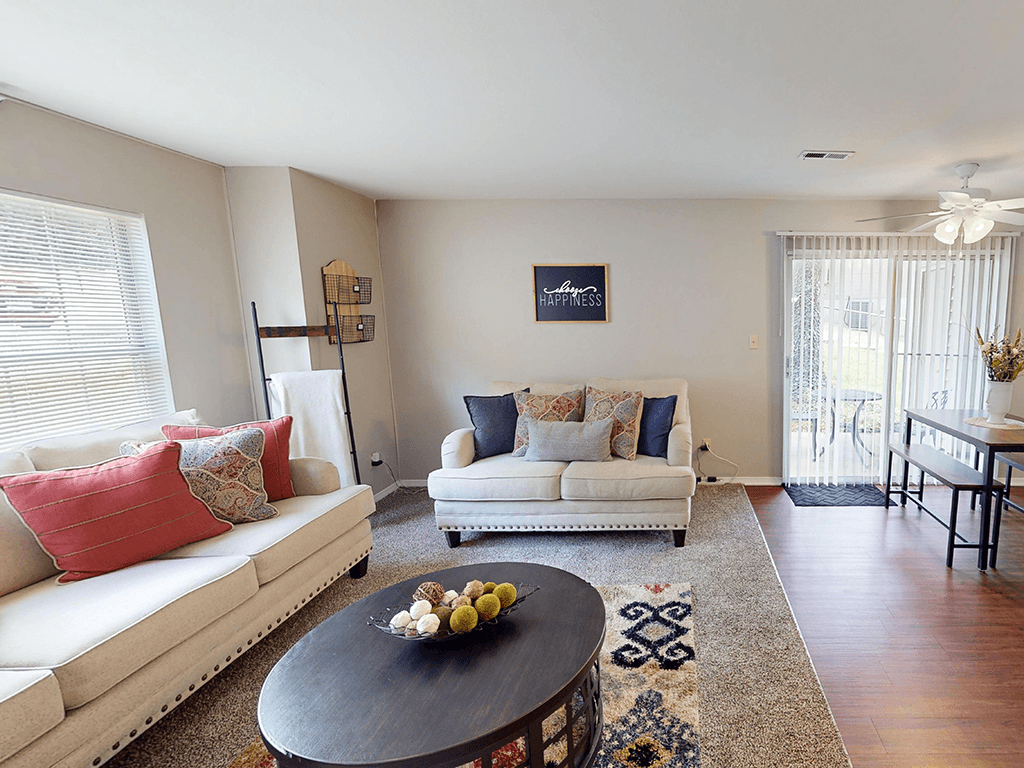 A living room with a white couch and a coffee table.
