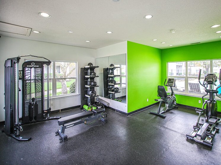 fitness center with weights at apartment community