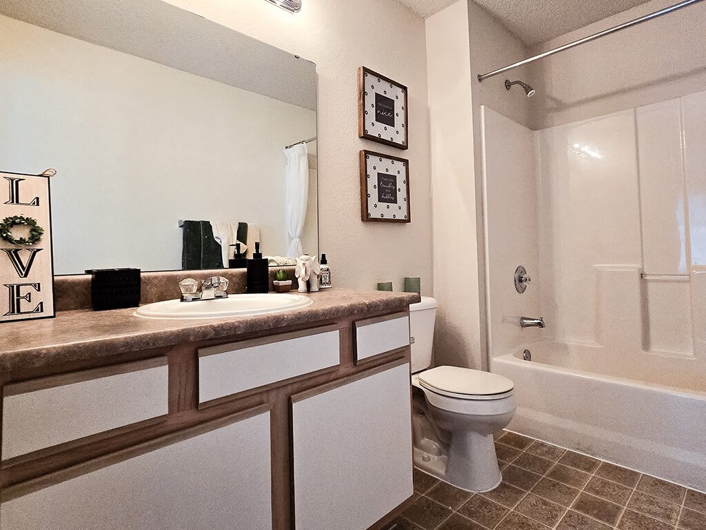a bathroom with a sink toilet and a shower