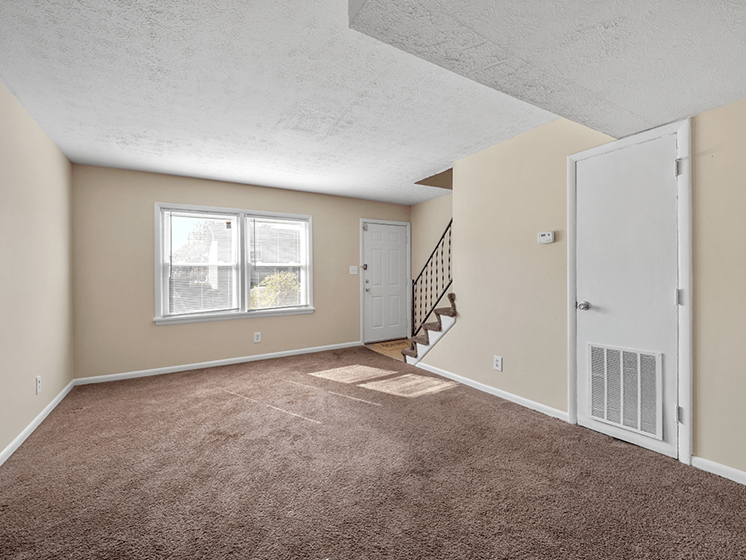 carpeted living room at Preston Oaks Apartments