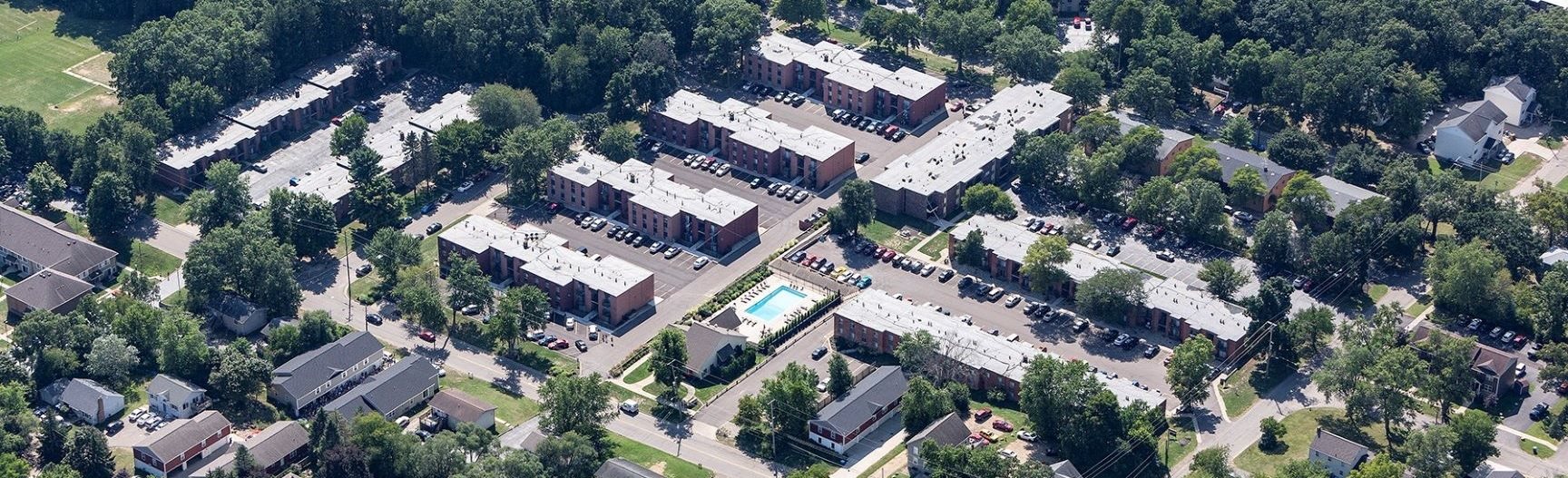 an aerial view of a city with houses and trees