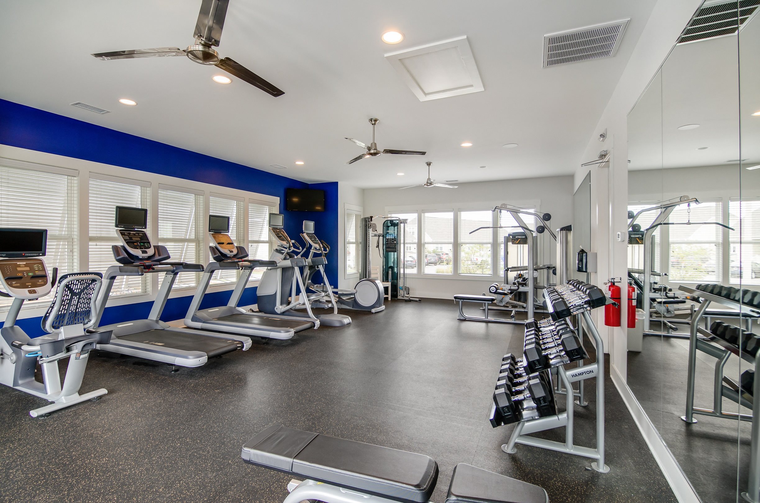 Wilmington NC Apartments for Rent - Spacious Fitness Center Featuring Various Cardio and Weight Equipment