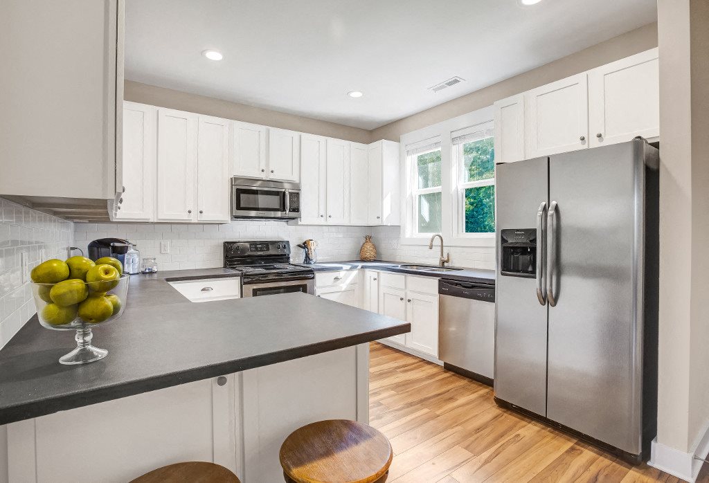 Apartments in Wilmington NC - Spacious Kitchen with Plenty of Storage and Counter Space and Convenient Amenities Such as Stove, Microwave, Dishwasher, and Fridge