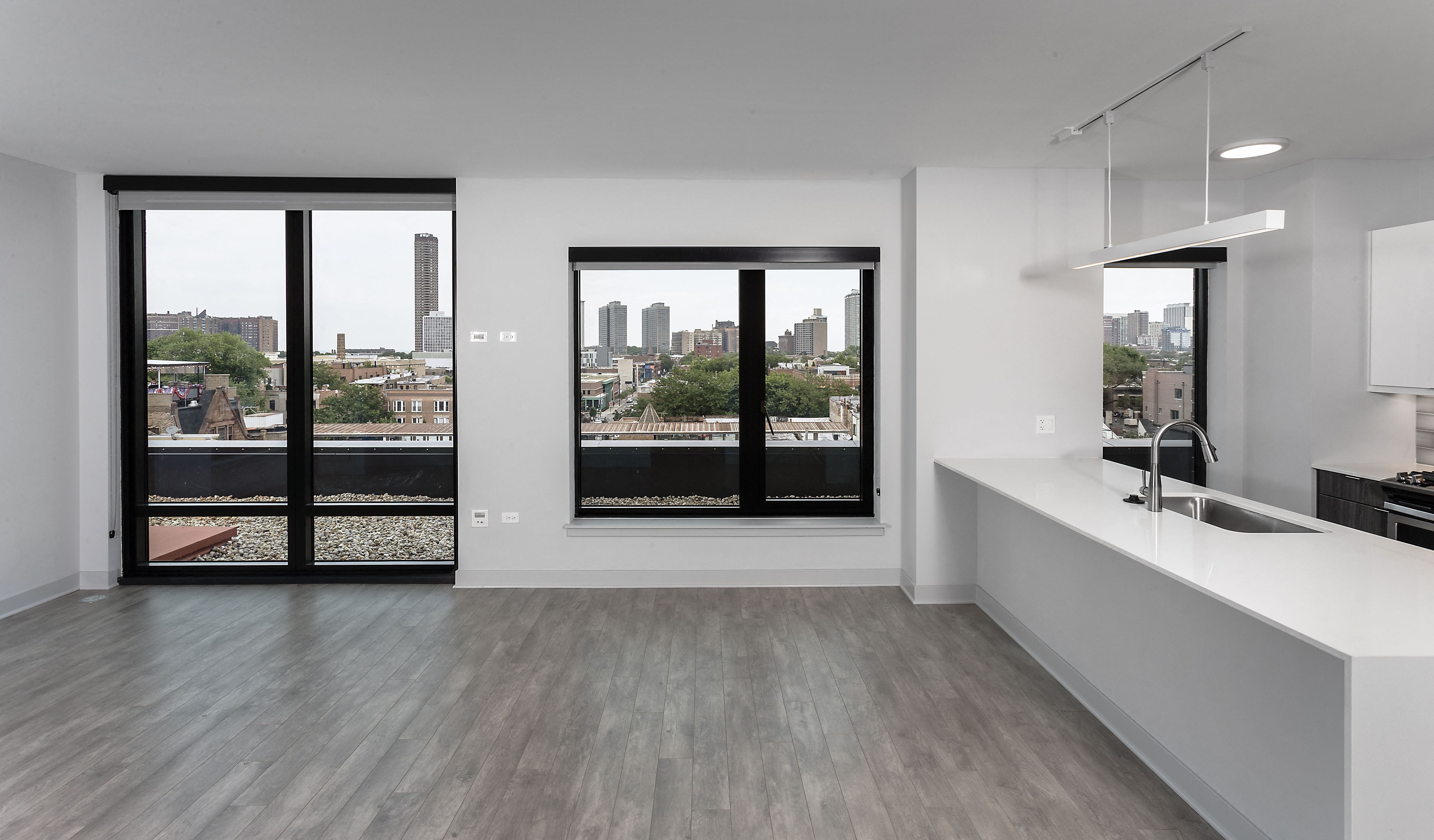 a kitchen with a large window and a white counter top at Residences at Addison Clark Apartments, Chicago, IL