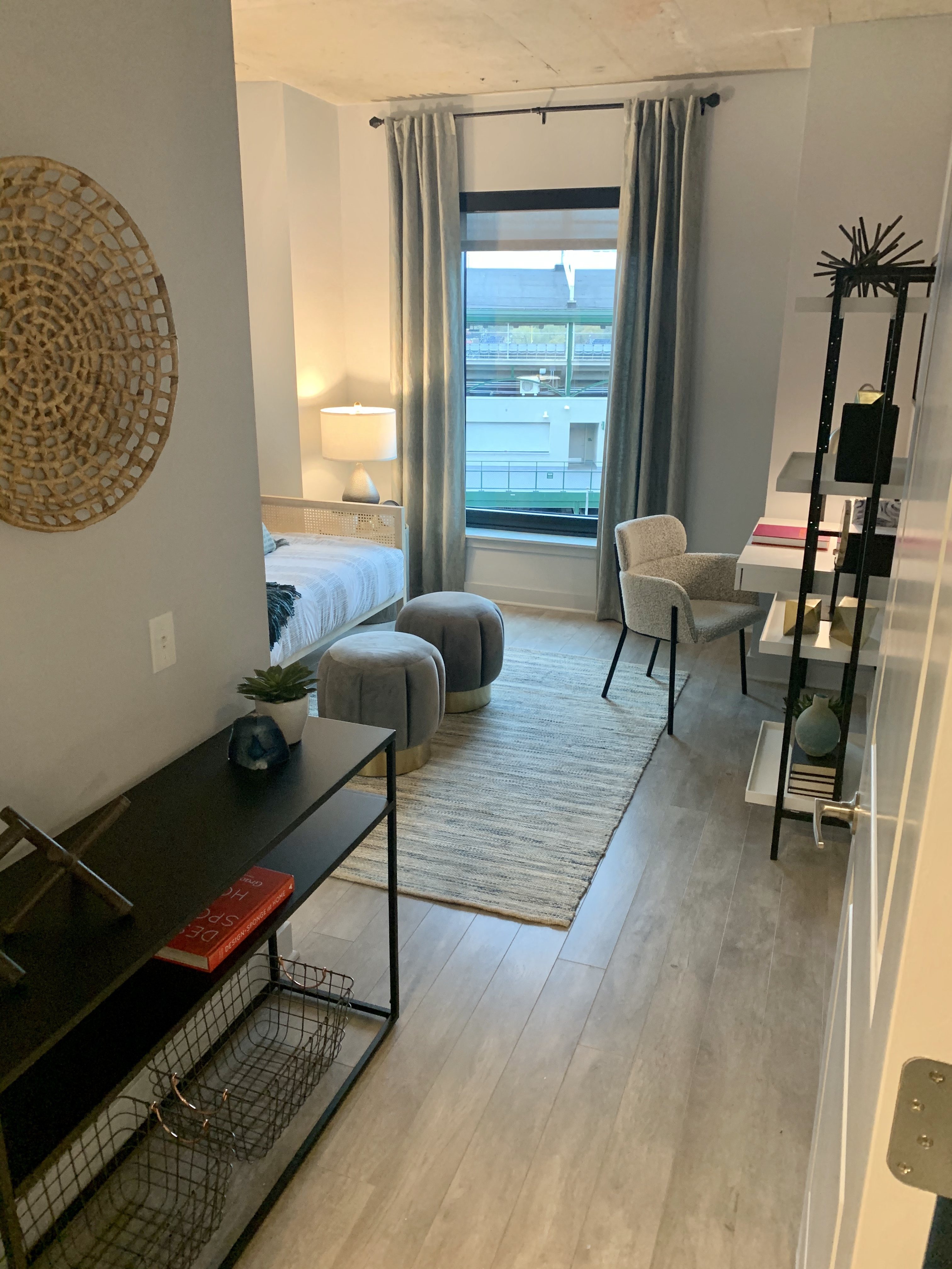 a living room with a bed and a sliding glass door at Residences at Addison Clark Apartments, Chicago, IL, 60613