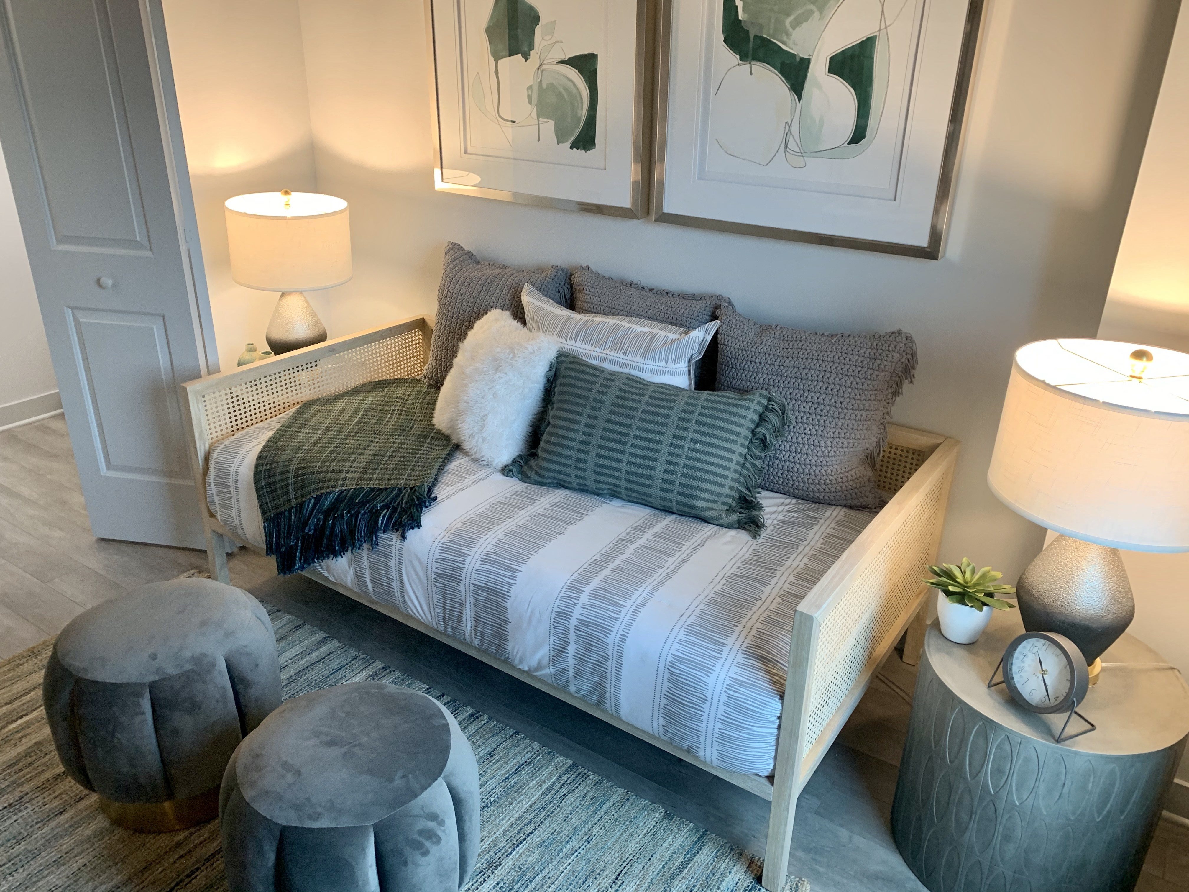 a bedroom with a bed with pillows and lamps at Residences at Addison Clark Apartments, Chicago, IL