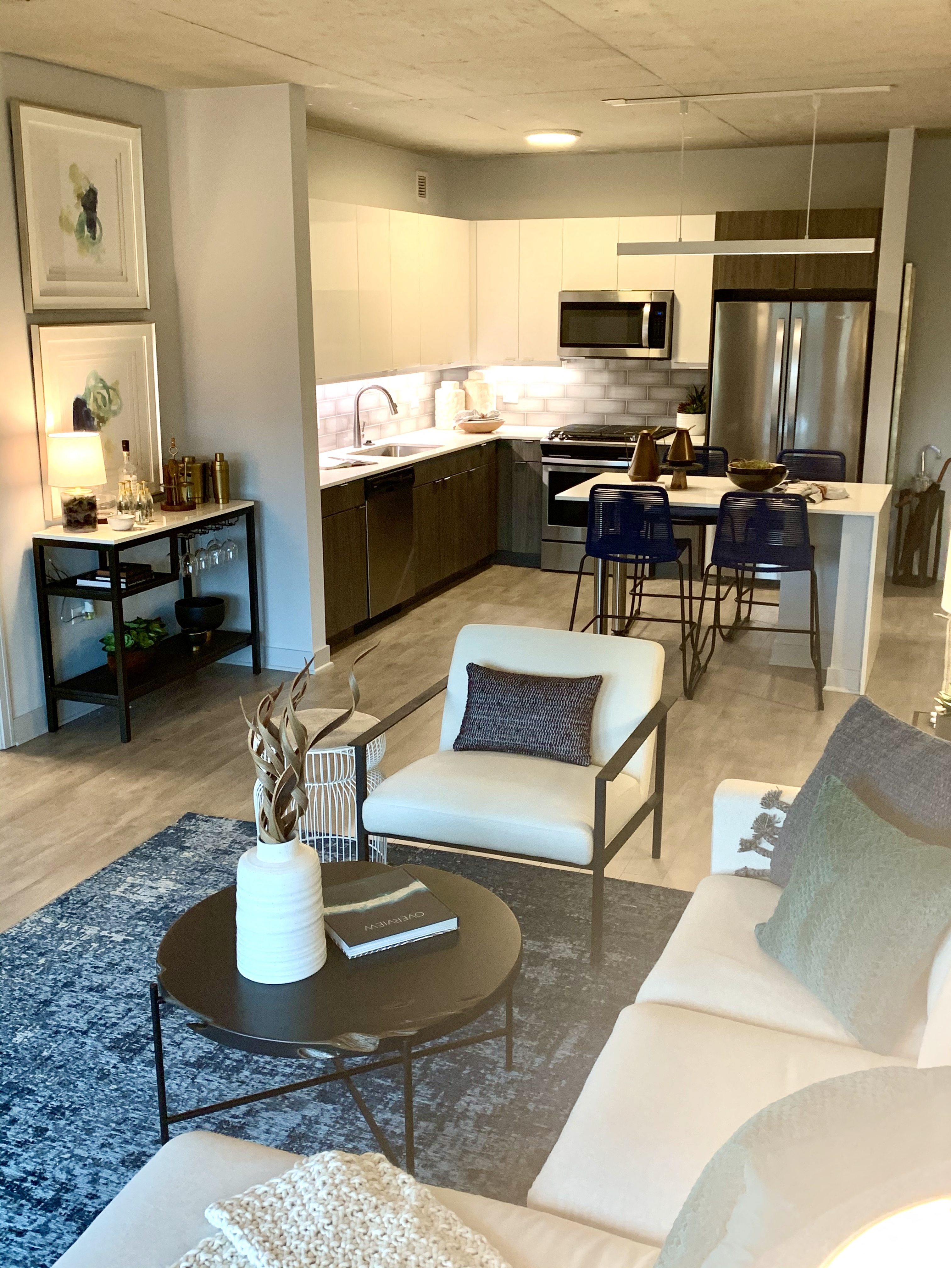a living room and kitchen with a couch and a table  at Residences at Addison Clark Apartments, Chicago, 60613