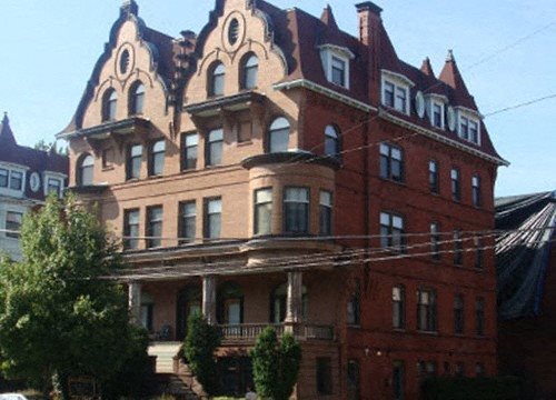 a large brick building with many windows and a roof