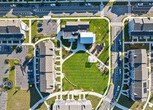 an aerial view of a campus with buildings and a field