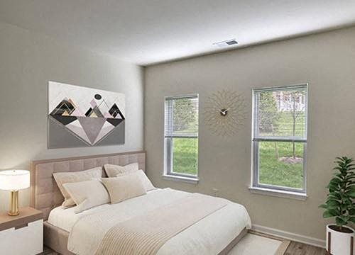 a bedroom with a bed and two windows
