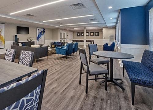 a lobby with tables and chairs and chairs