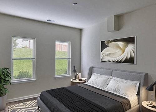 a bedroom with a bed and a painting on the wall