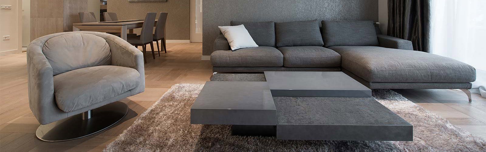 A grey sofa and chair in a modern living room.