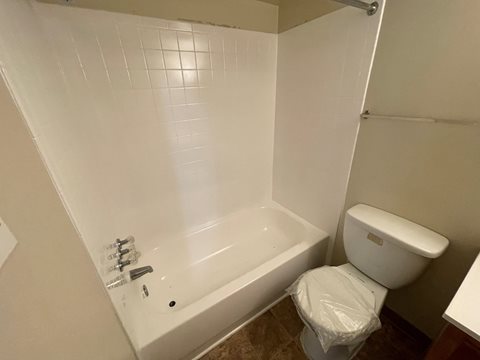 a bathroom with a bathtub and a toilet