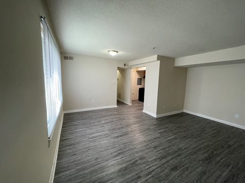 a photo of an empty living room with a hardwood floor