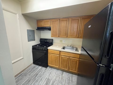 a kitchen with a stove refrigerator and sink