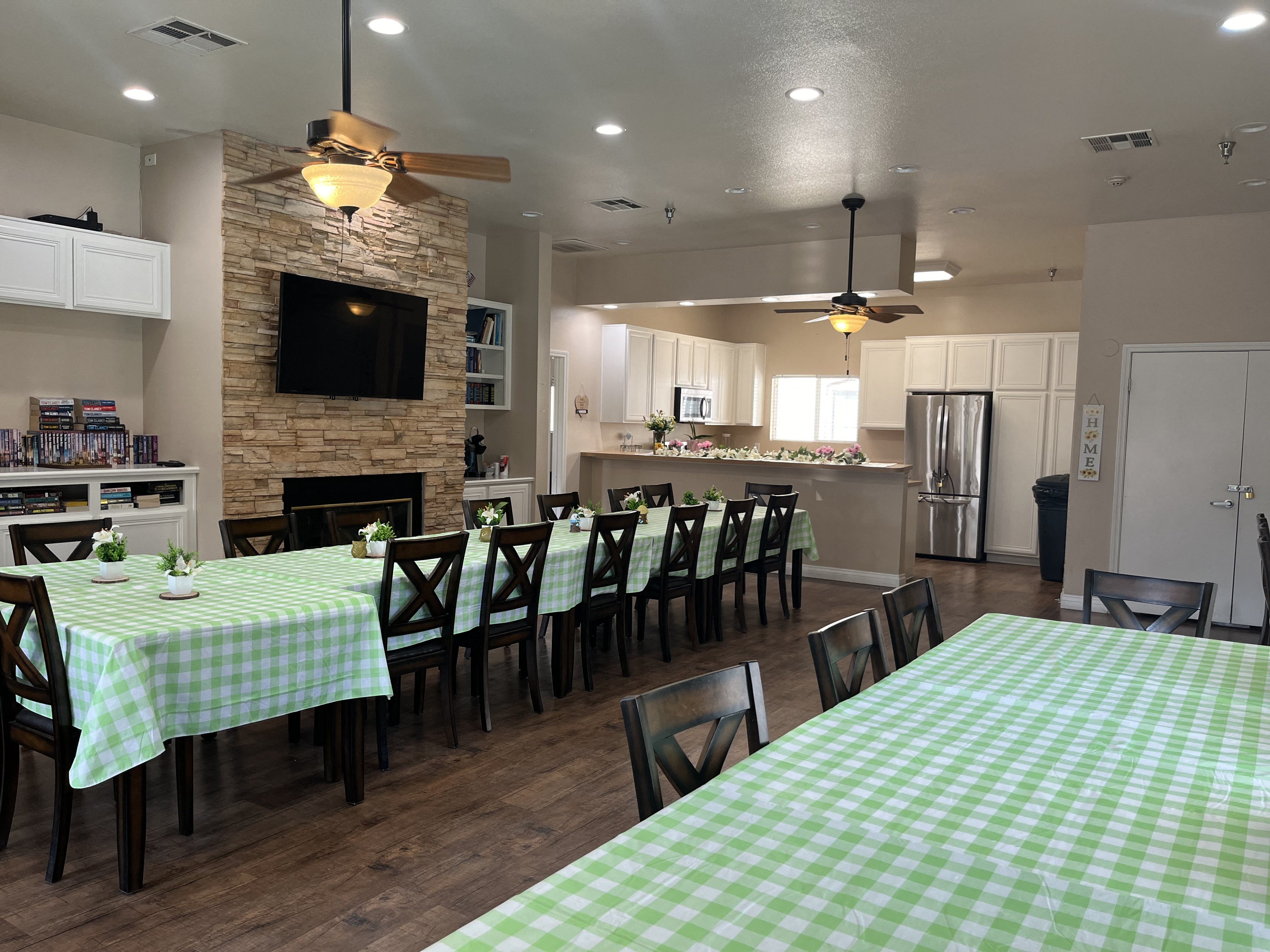 a dining room and kitchen with a table and chairs and a fireplace