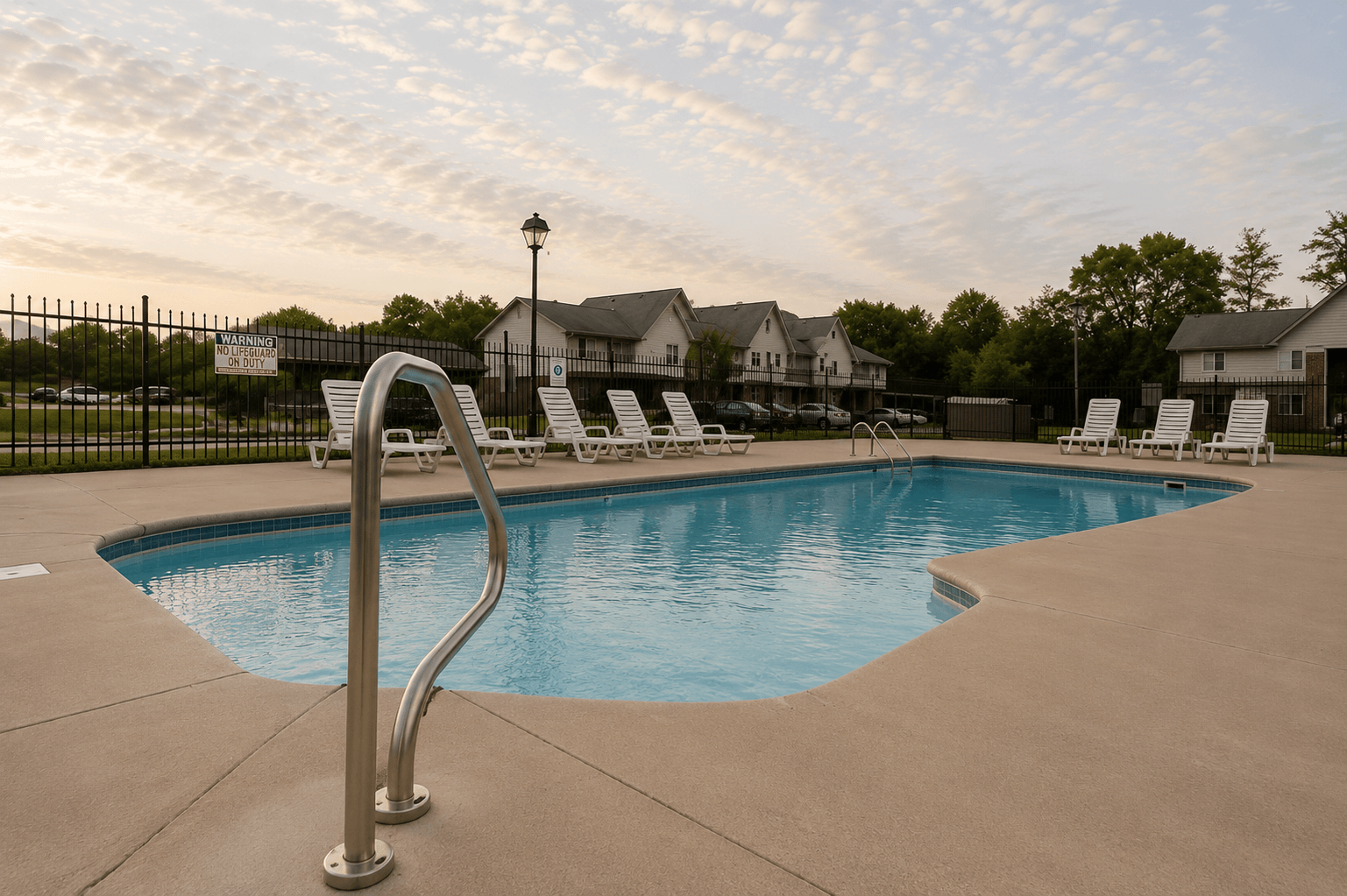 A swimming pool with a metal ladder in the foreground.
