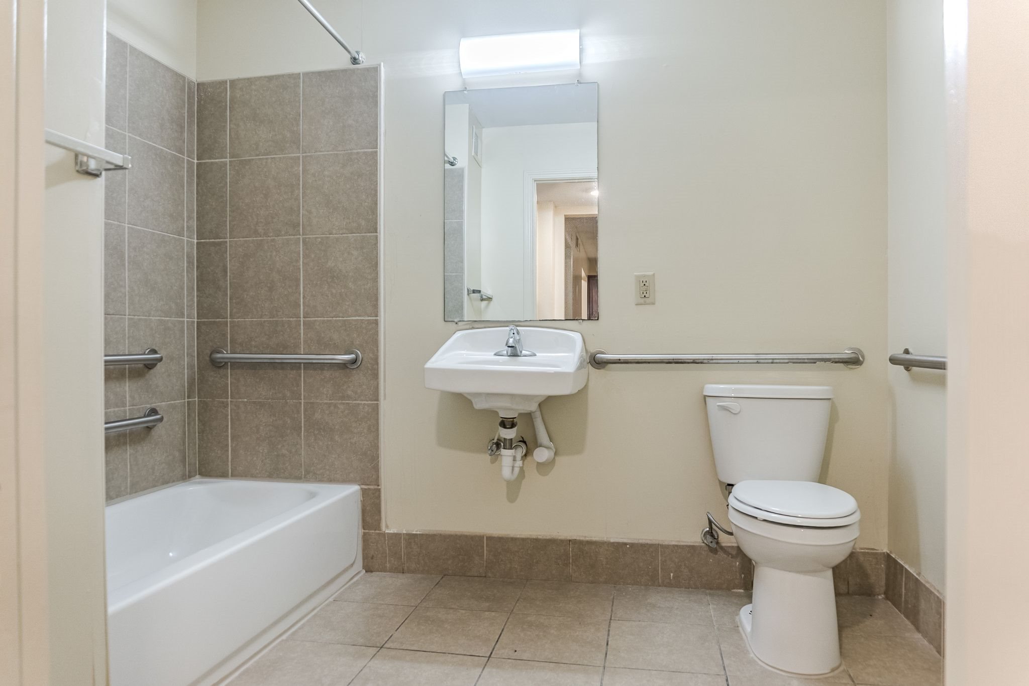 A white toilet sits next to a sink in a bathroom.