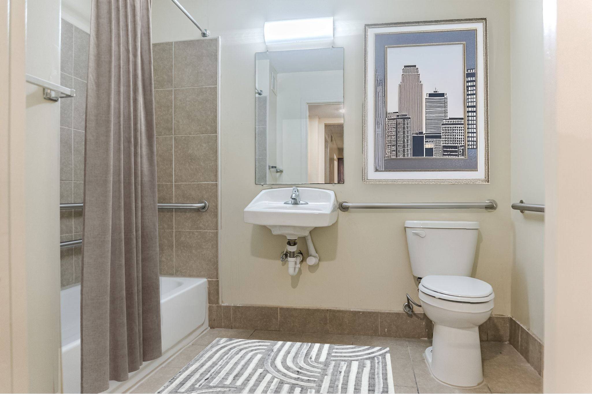 A bathroom with a toilet, sink, and shower.