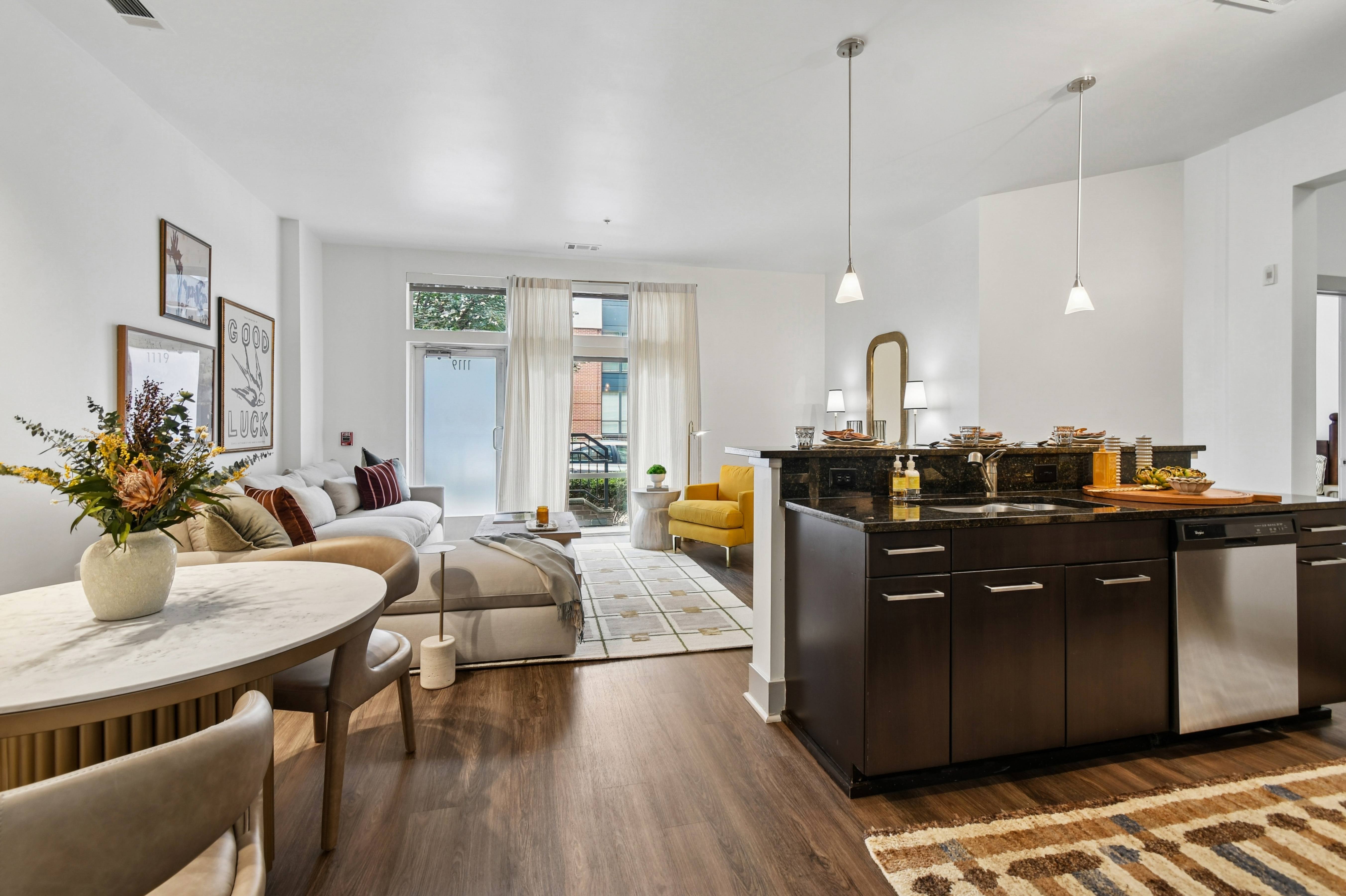 A modern kitchen with dark wood cabinets and a white countertop.