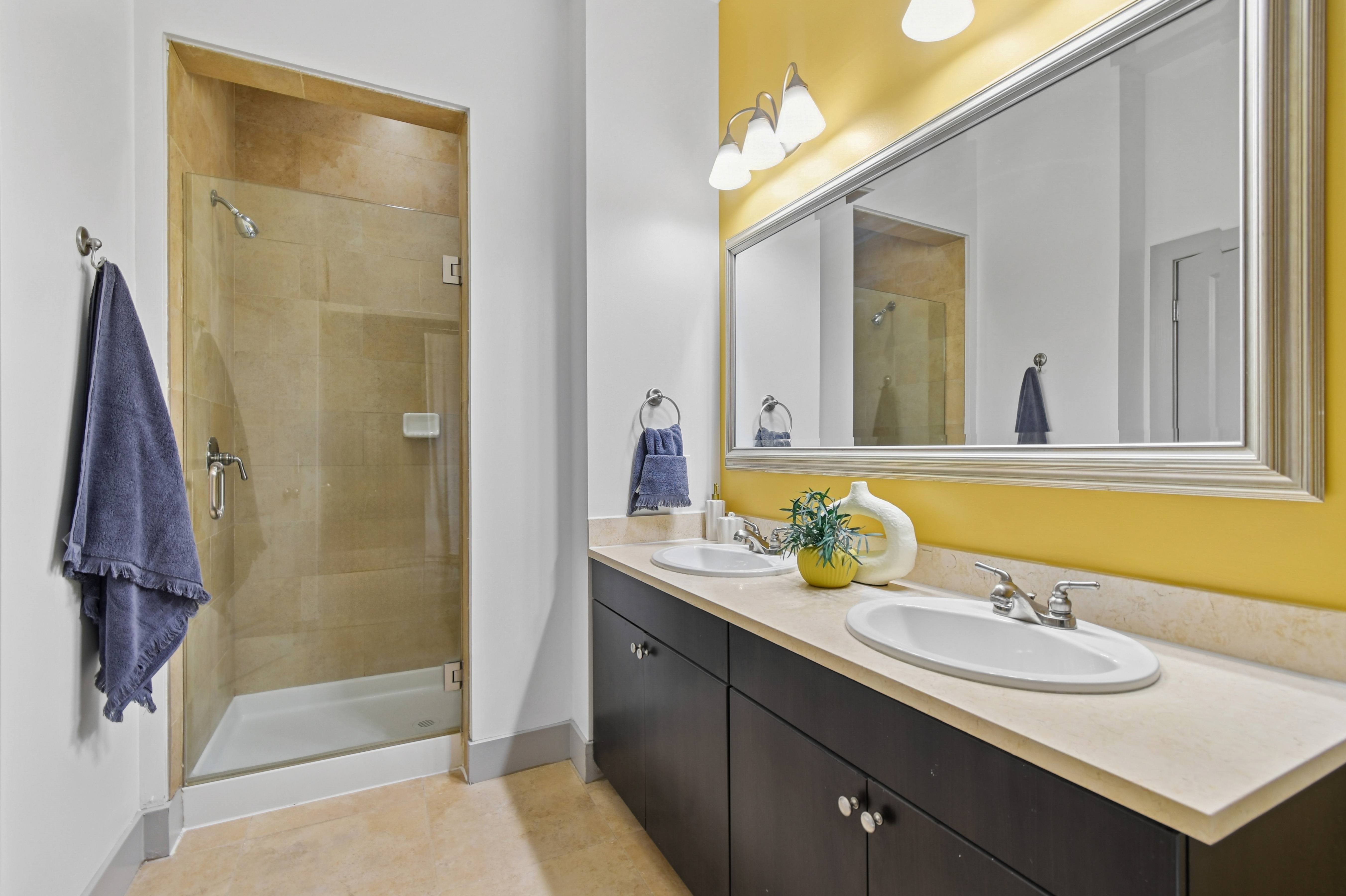 A bathroom with a yellow wall and a white sink.