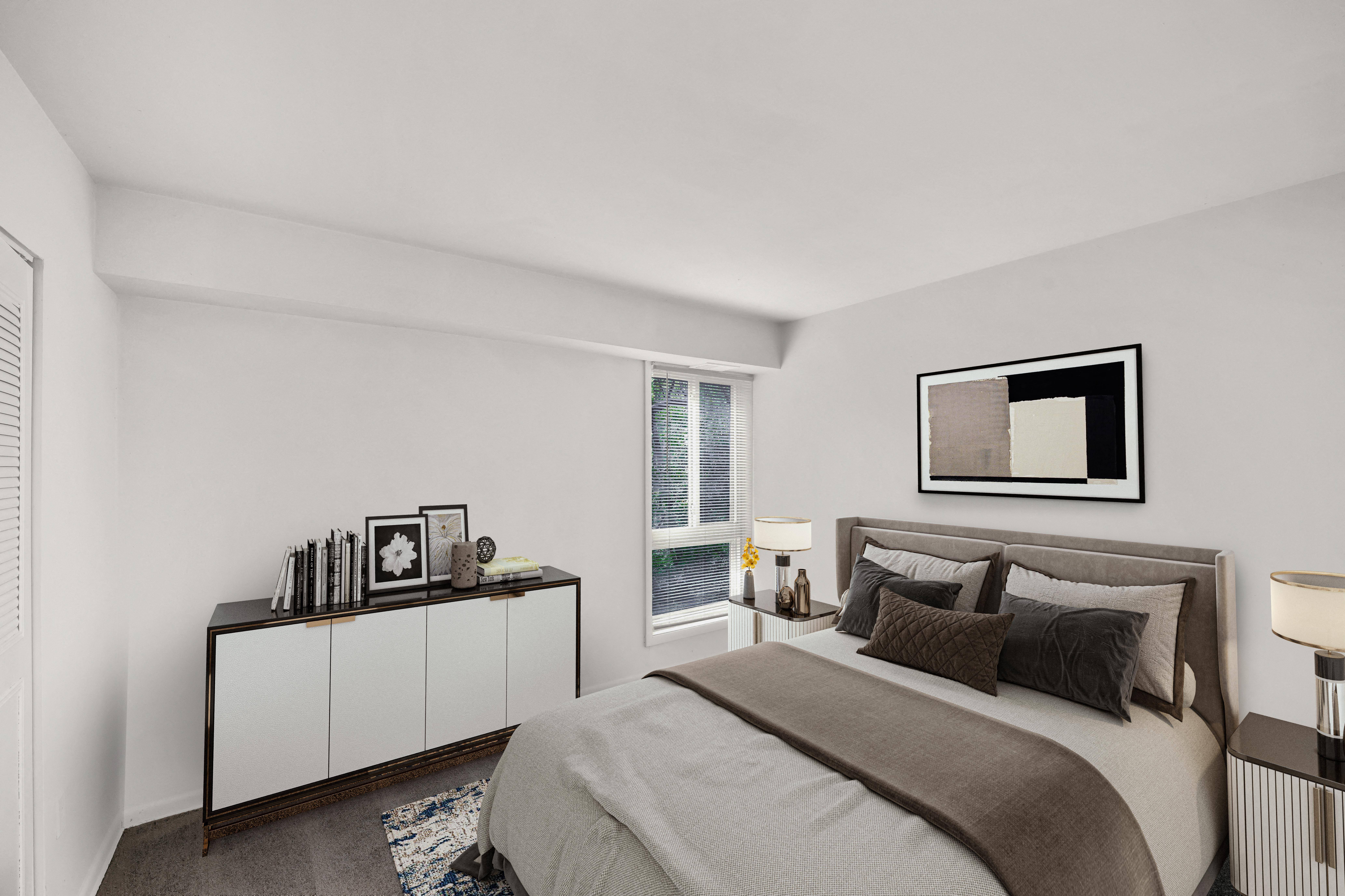 a bedroom with a bed and a large window