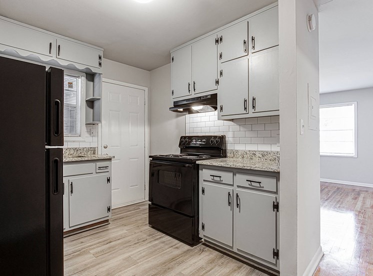 1295 west kitchen with white cabinets and black appliances