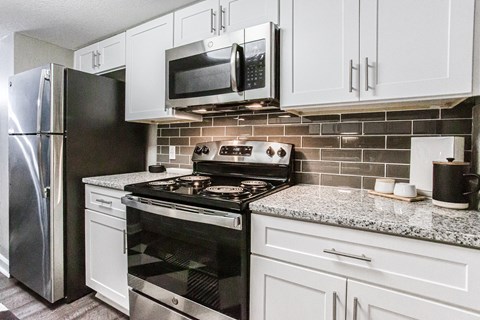 Kitchen With White Cabinetry And Appliances at Atler at Brookhaven, Atlanta