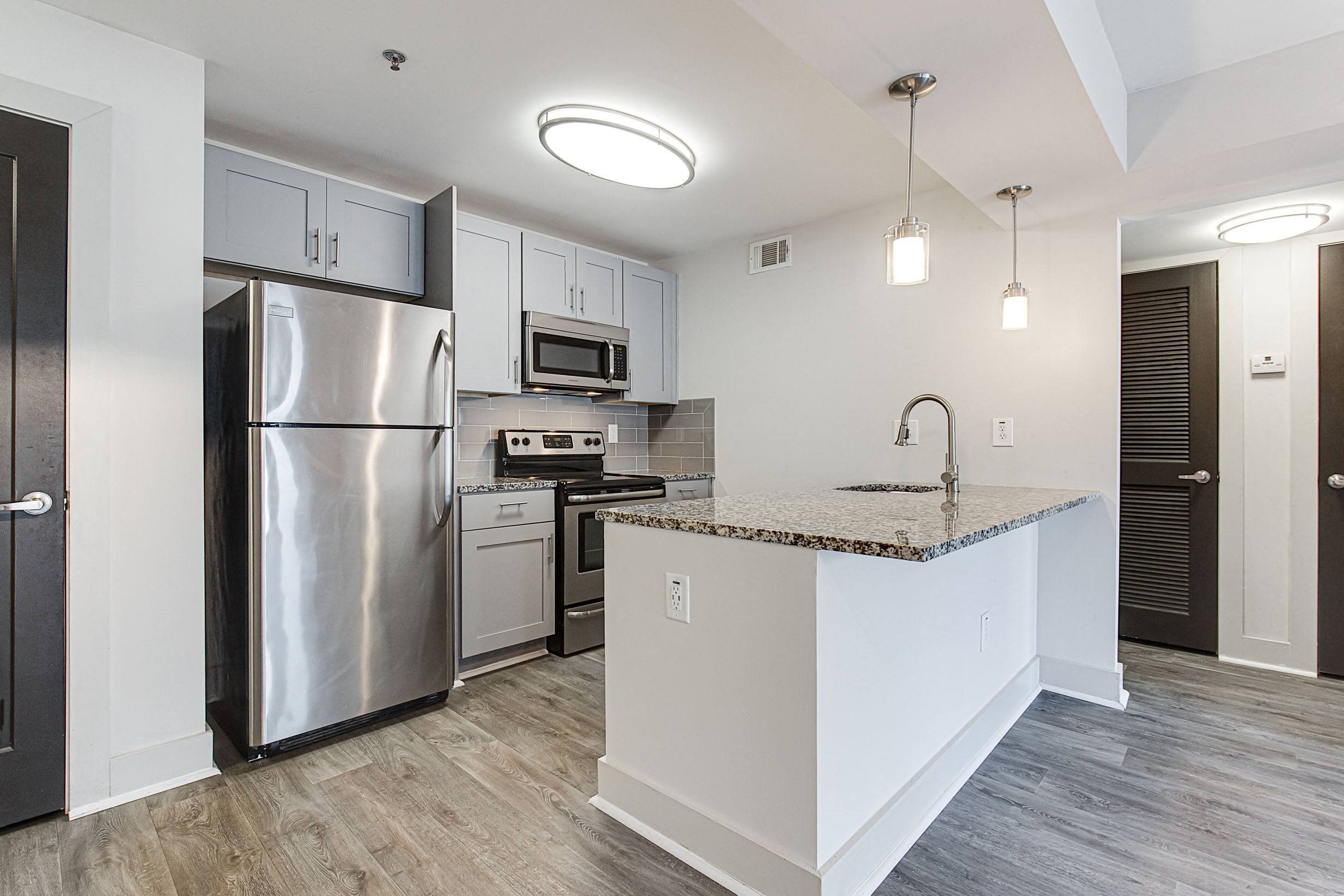 a kitchen with stainless steel appliances and a granite counter top