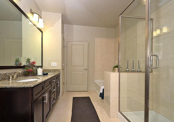 a bathroom with a shower sink and bathtub