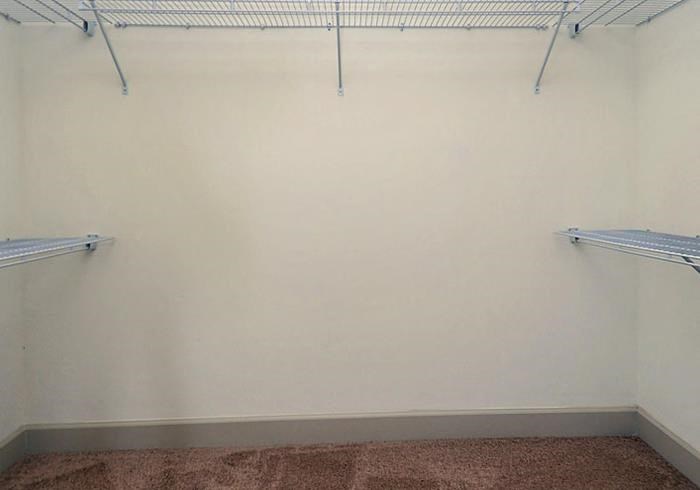 a empty room with two empty shelves on the wall