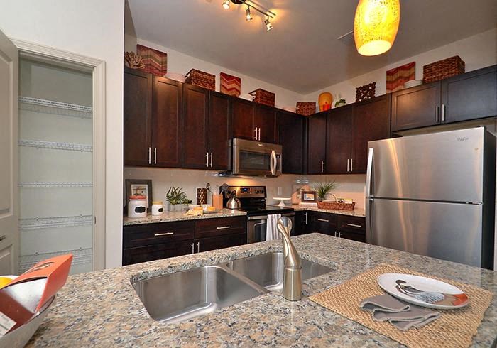 a kitchen with a granite counter top and stainless steel appliances