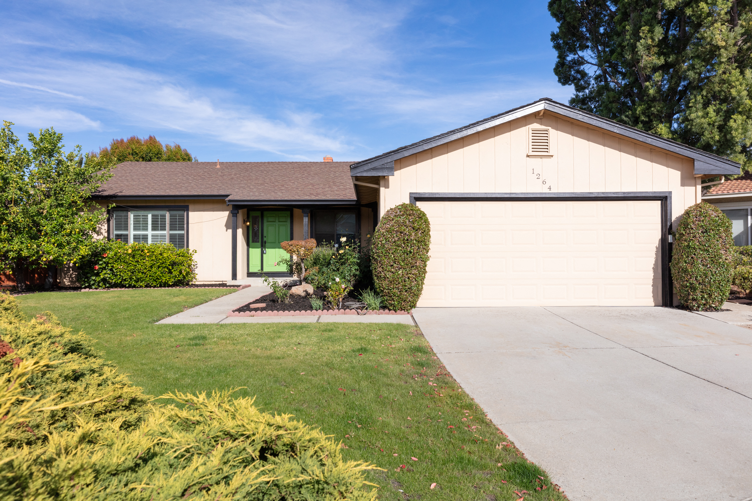 a white house with a driveway and a garage door